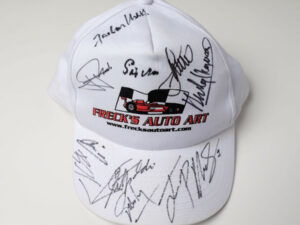 Freck’s Auto Art Cap Signed by Penske, Moss, Montoya, Fittipaldi + 7 more